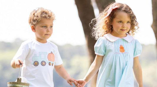 little boy and girl holding hands in halloween outfits