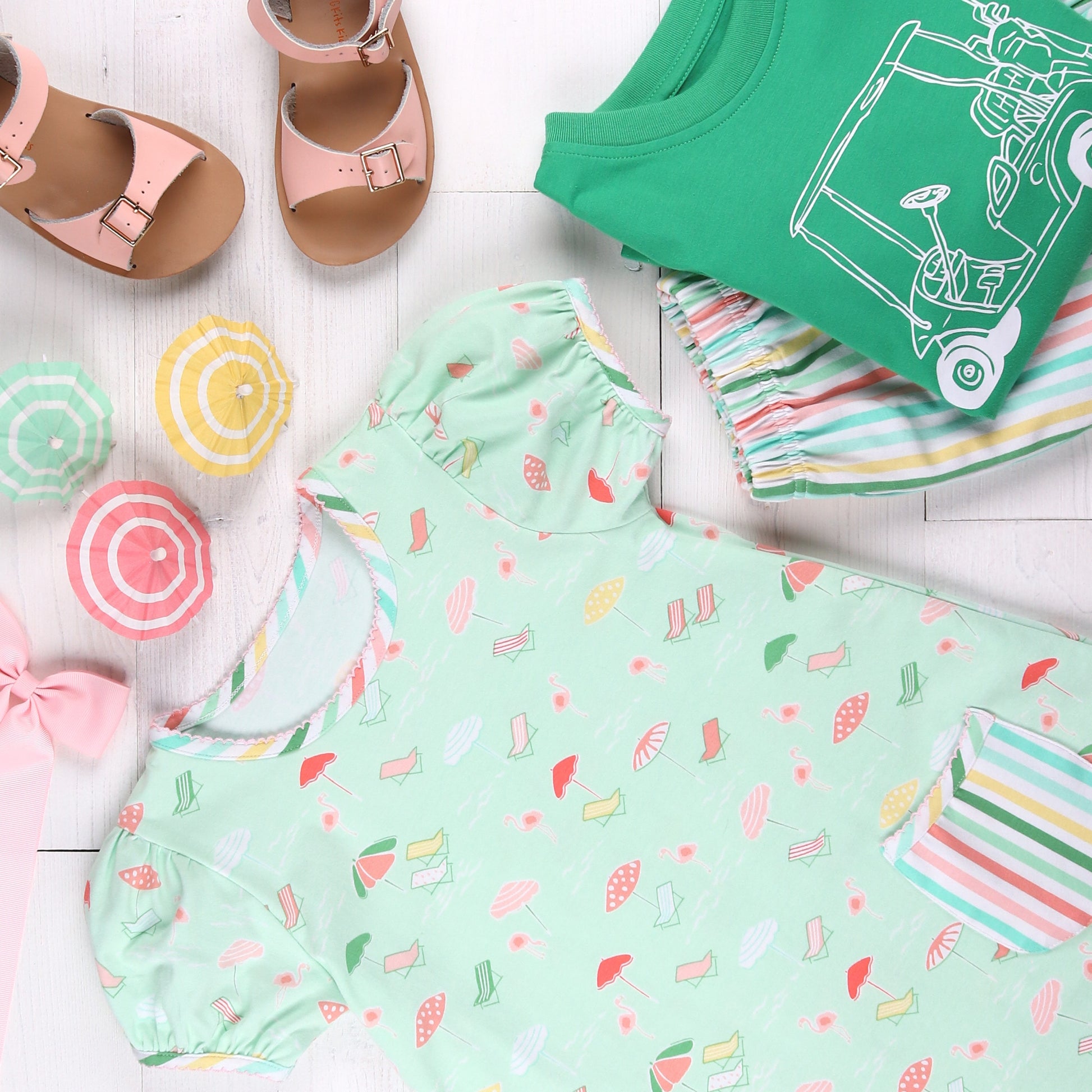 flatlay of Beach Club Stripe Shorts, pink sandals and tshirt