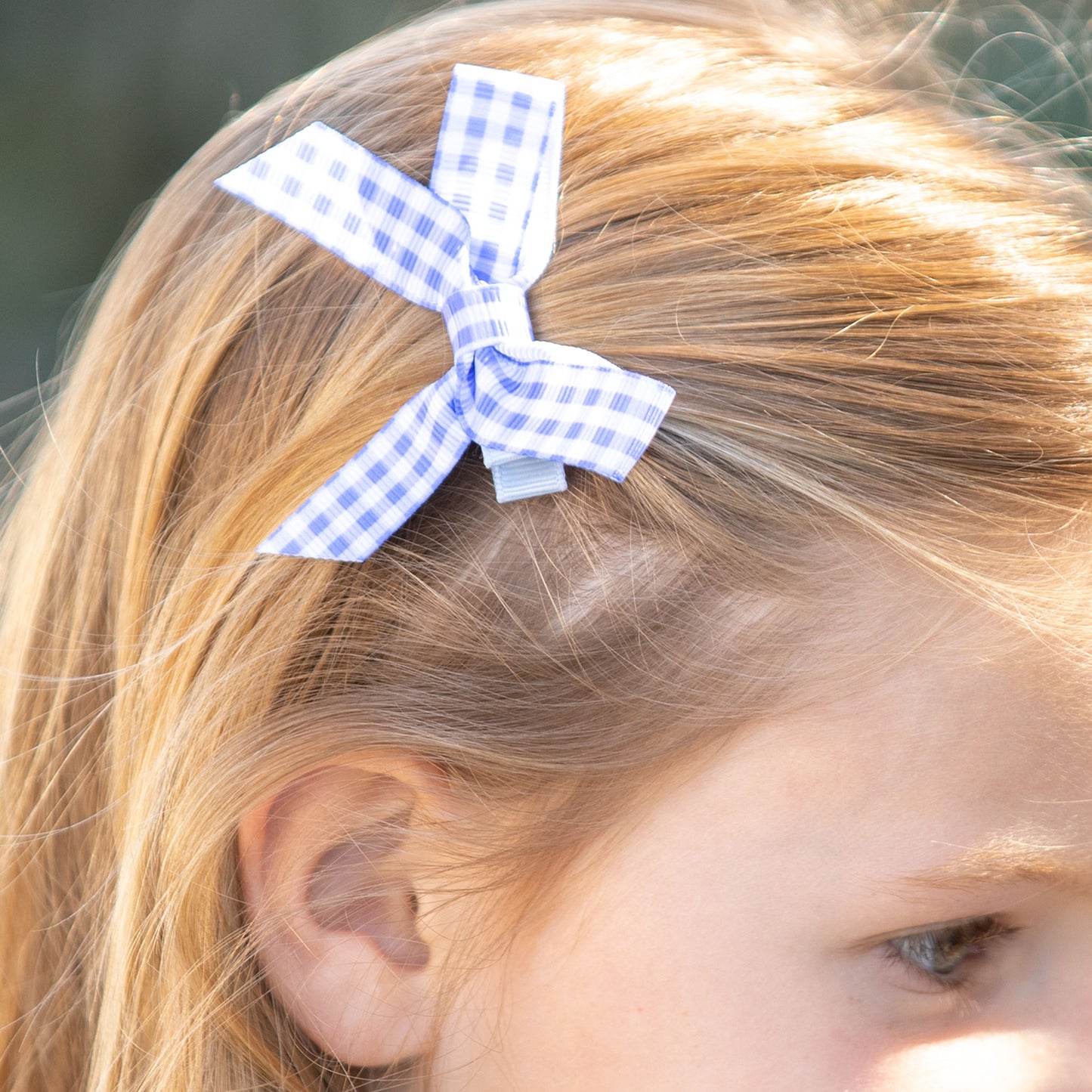 little girl wearing Blue Check Bitty Bow in her hair