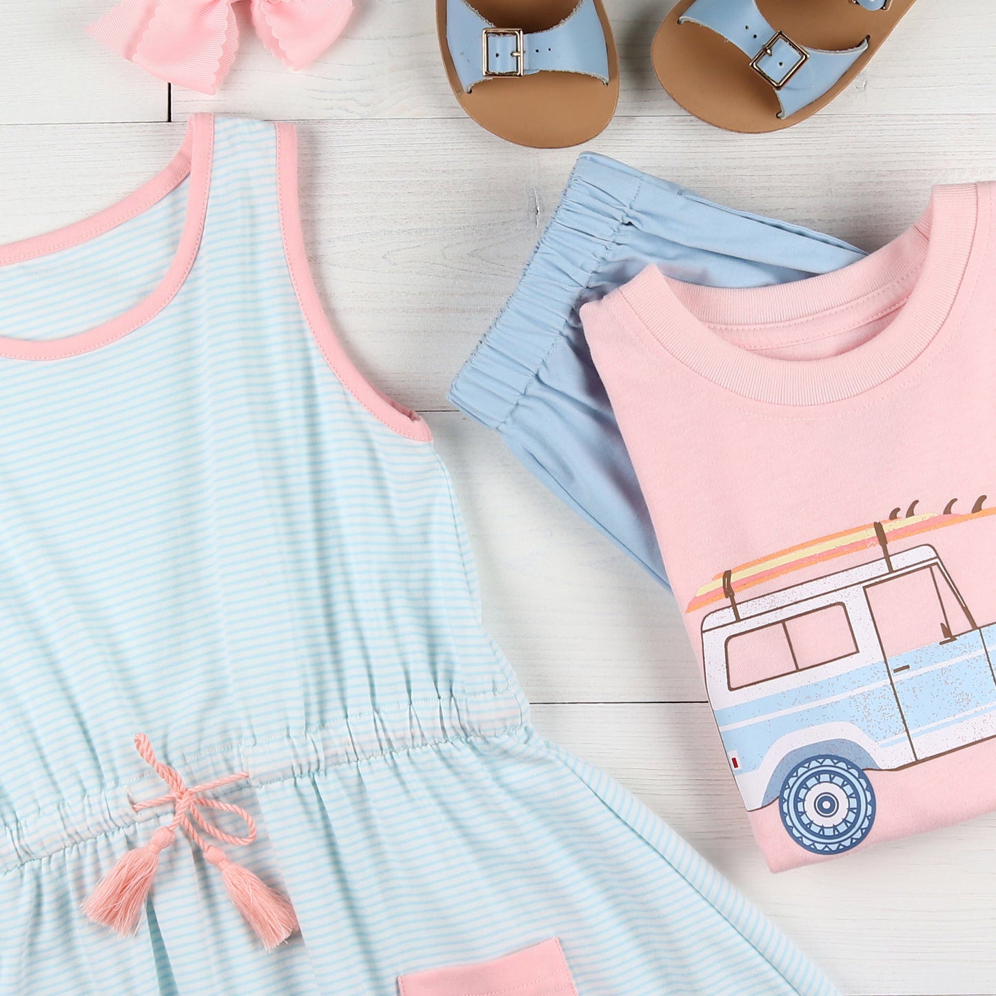 flatlay of Tennis Club Jordan Dress, light blue shorts, tshirt