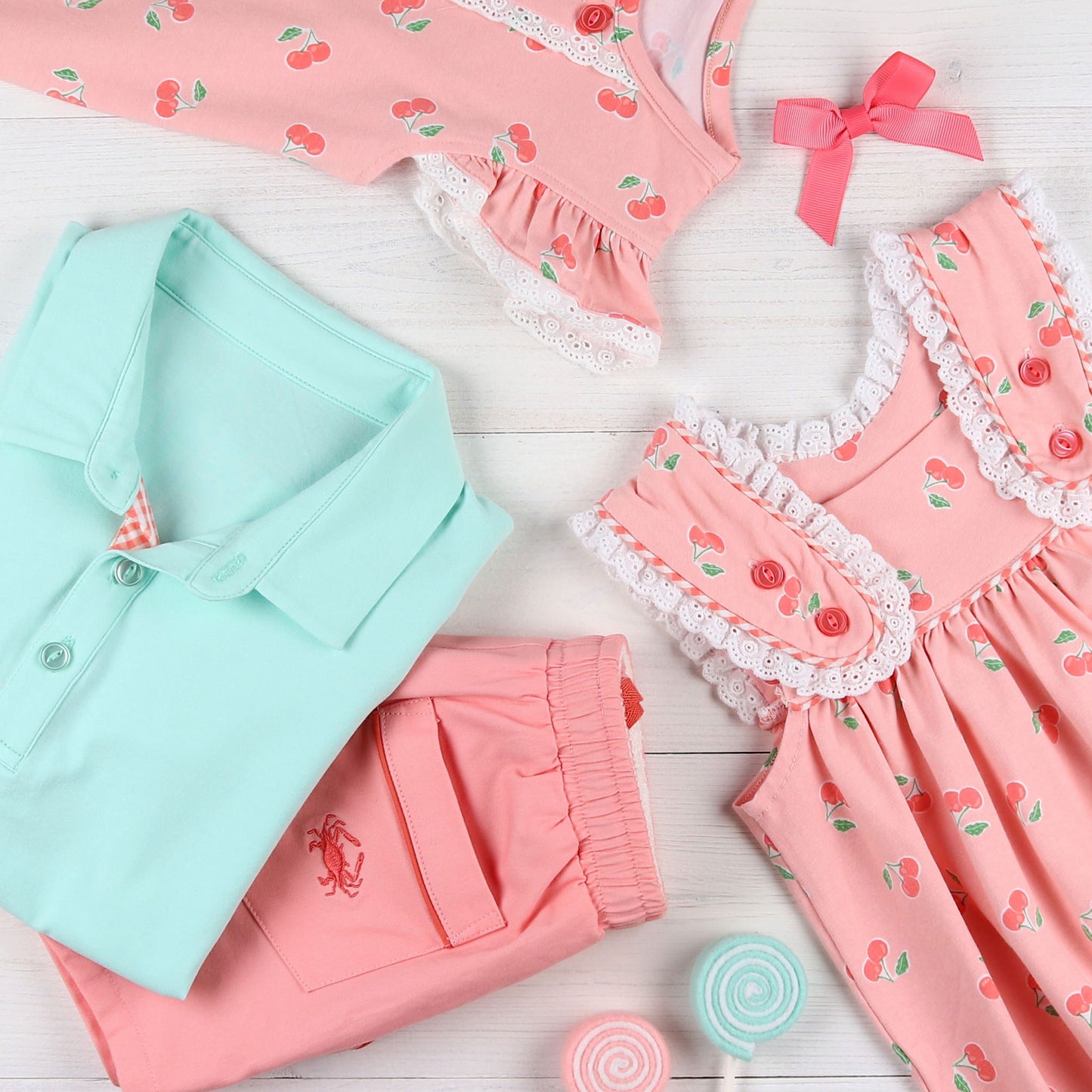 flatlay of Cherry Blossom Swing Top, aqua polo and crab shorts