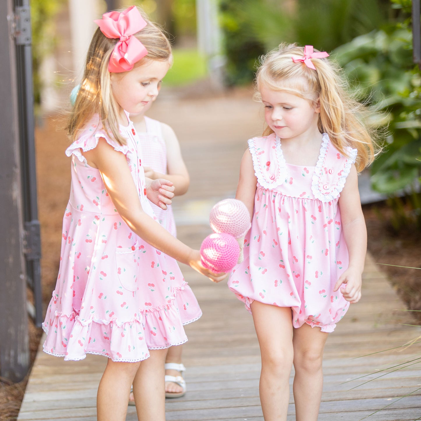 a little girl wearing Girls Cherry Blossom Bubble and playing with another little girl