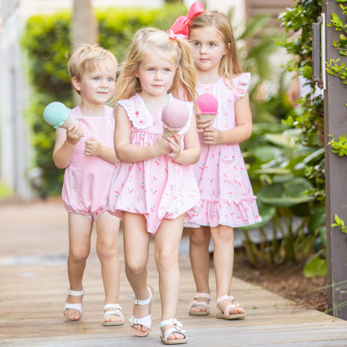 little girl wearing Girls Cherry Blossom Bubble and walking down the sidewalk with cloth toy ice cream cones