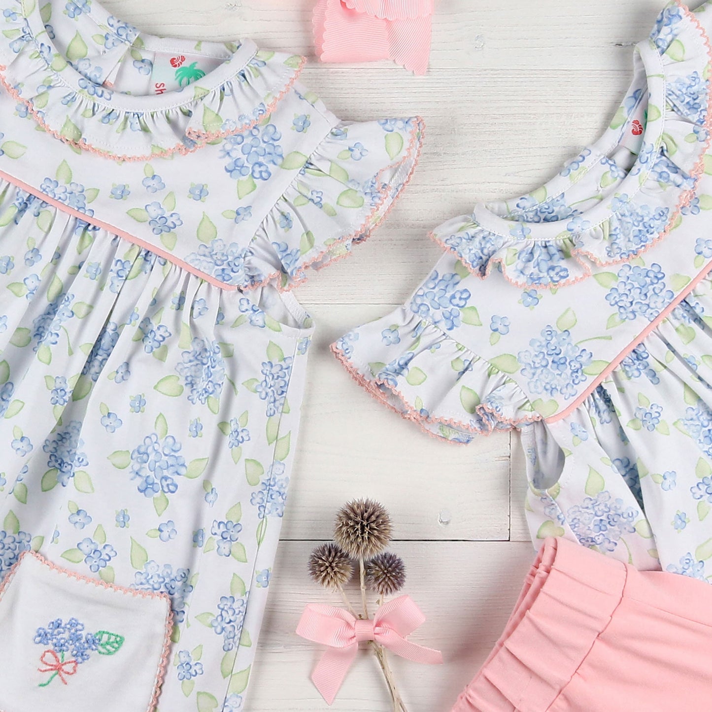 flatlay of shorts, dresses and pink shorts