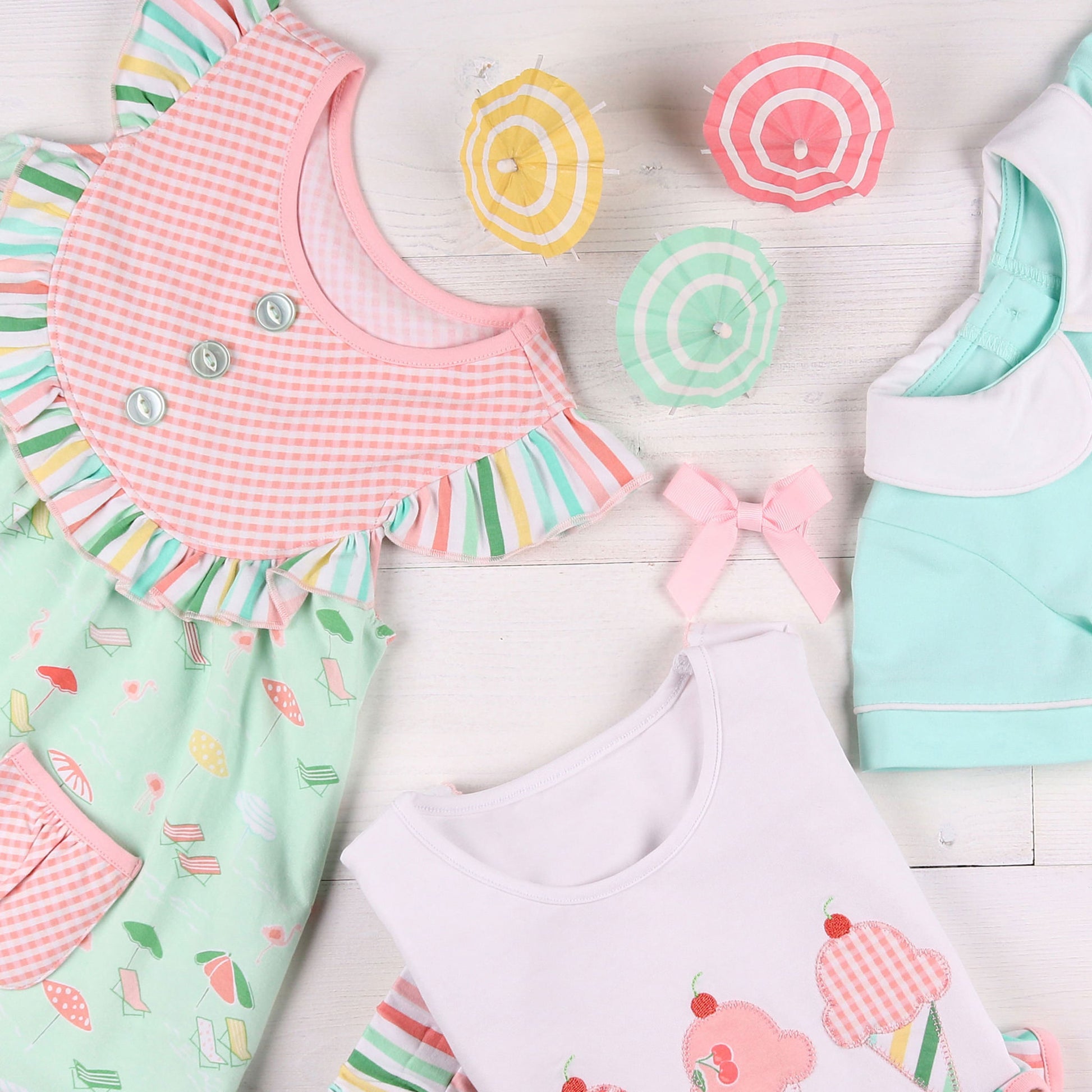 flatlay of ice cream tshirt and dress and aqua bubble