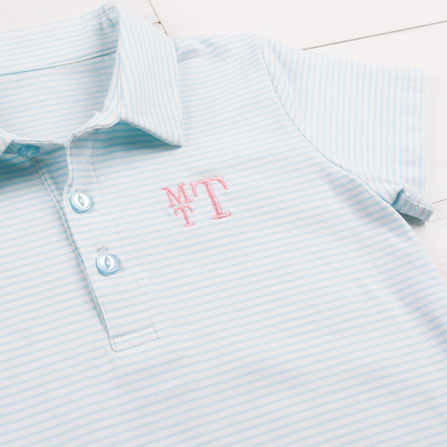close up of a monogram on a Tennis Club Stripe Polo