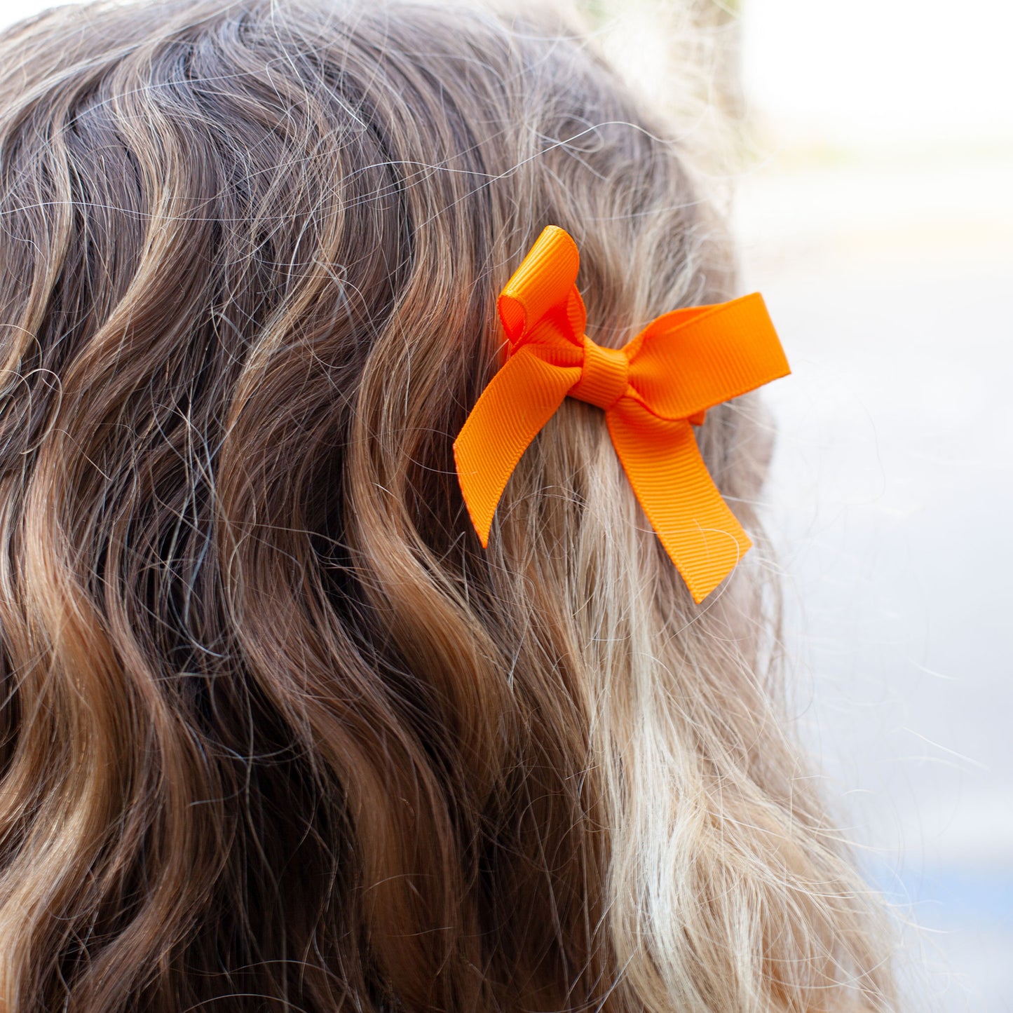 little girl wearing a Orange Bitty Bow