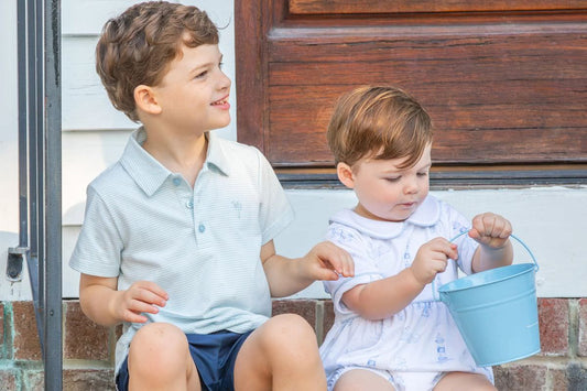 2 boys sitting on porch