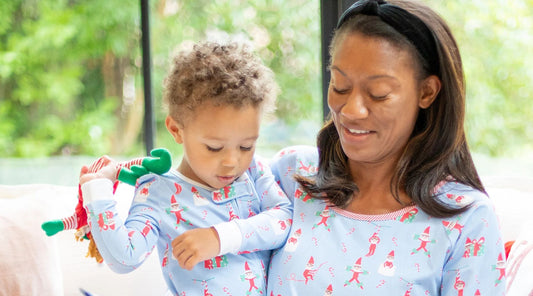 mom and son reading a book in Christmas pajamas