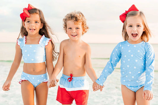 kids in bathing suits at the beach