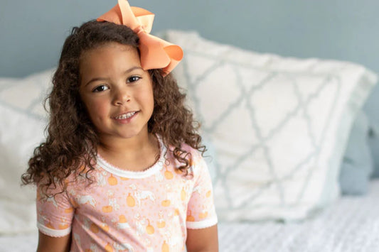 little girl in pumpkin pajamas - girls pajama sets