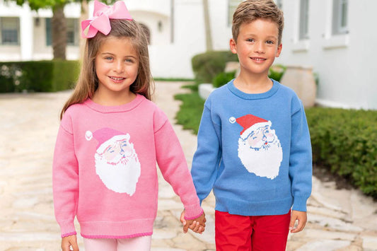 siblings in santa sweaters