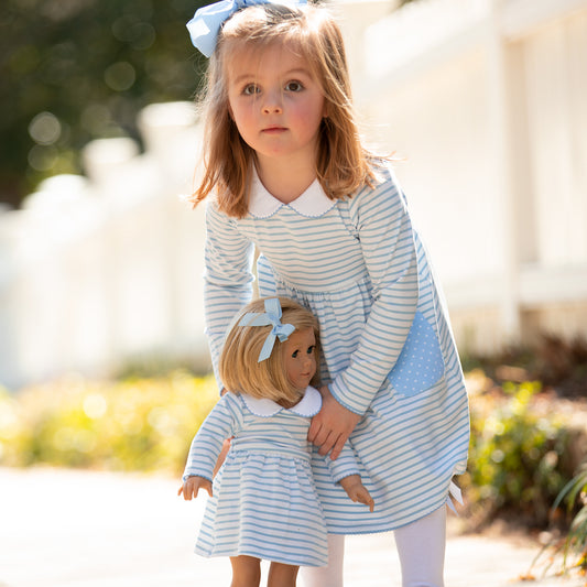 girl and dolls in matching clothing