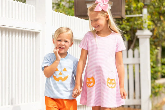 boy and girl in pumpkin outfits