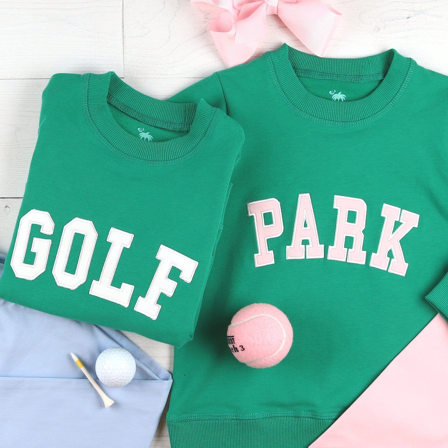 Golf and Park green kids sweatshirts shown together
