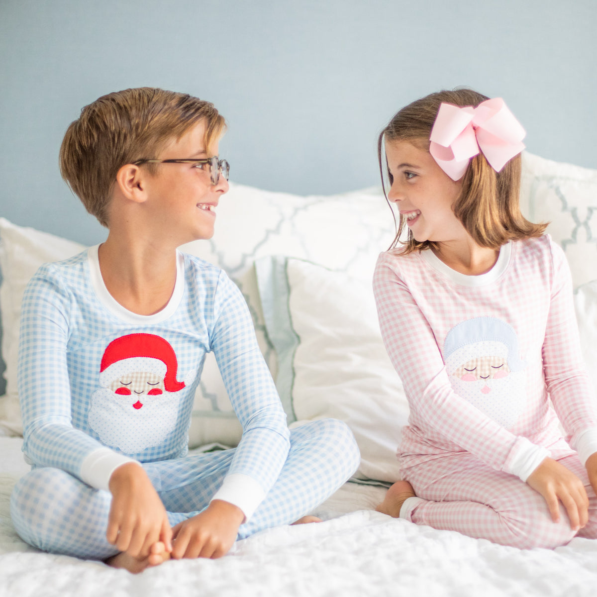 Matching boys and girls Christmas bamboo pajamas with vintage Santa appliqués
