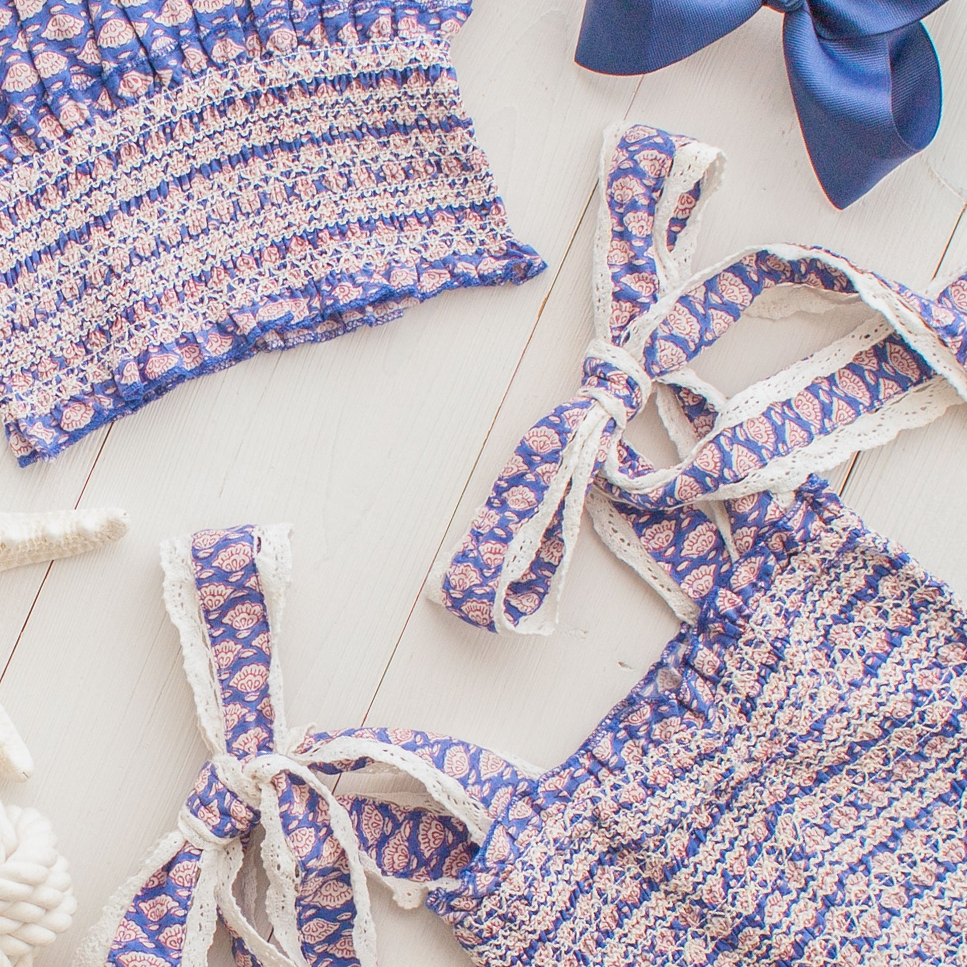 flatlay of Bahama Blue Woman's Top and a blue bow