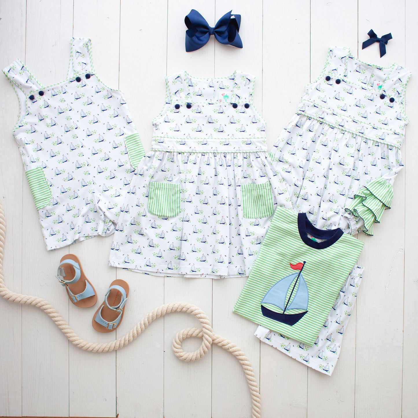 flatlay of Beneteau Pocket Dress with sandals and sailboat shirt