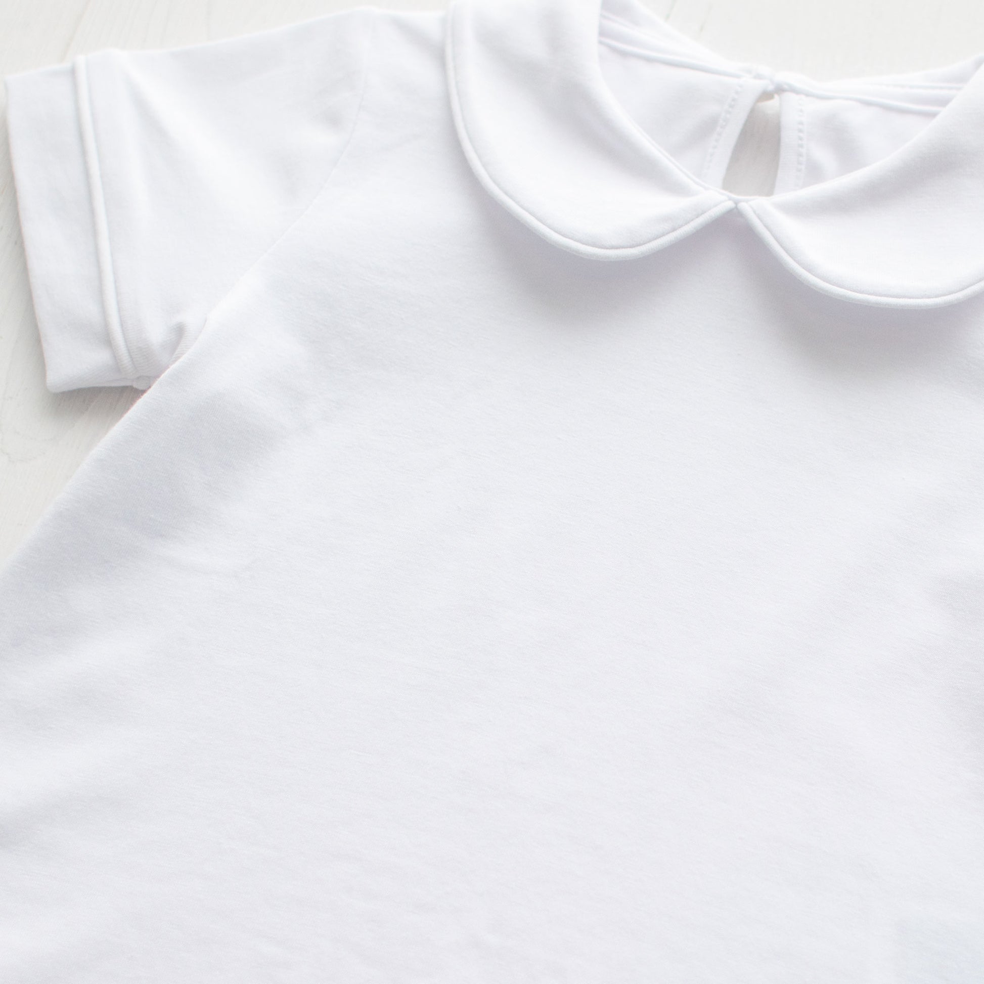 close up of Boys Short Sleeve White Knit Collared Top