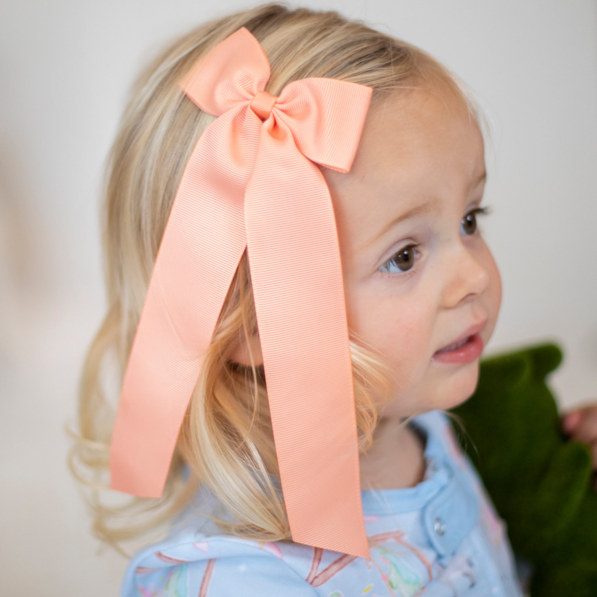 little girl wearing a Peaches Birdie Hair Bow
