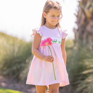 little girl wearing Kiawah Pink Smocked Alligator Dress