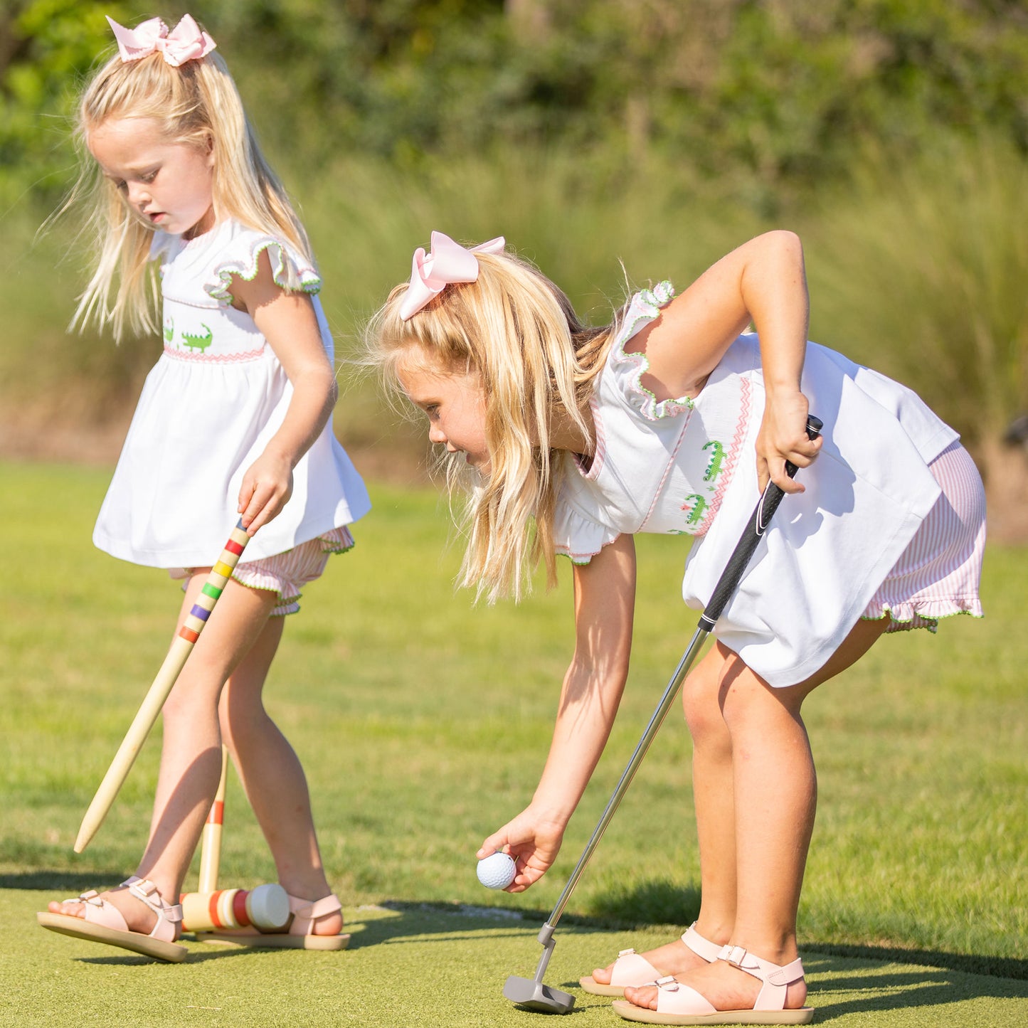 2 little girls playing golf