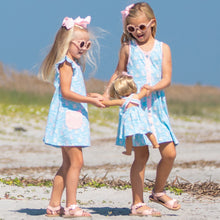 Load image into Gallery viewer, two little girls playing on the beach with a babydoll