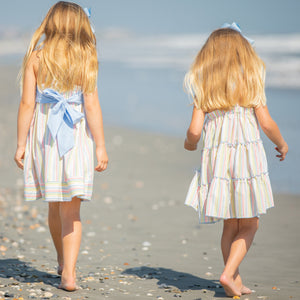 little girl wearing Girl's Secret Garden Dress walking down the beach with another little girl