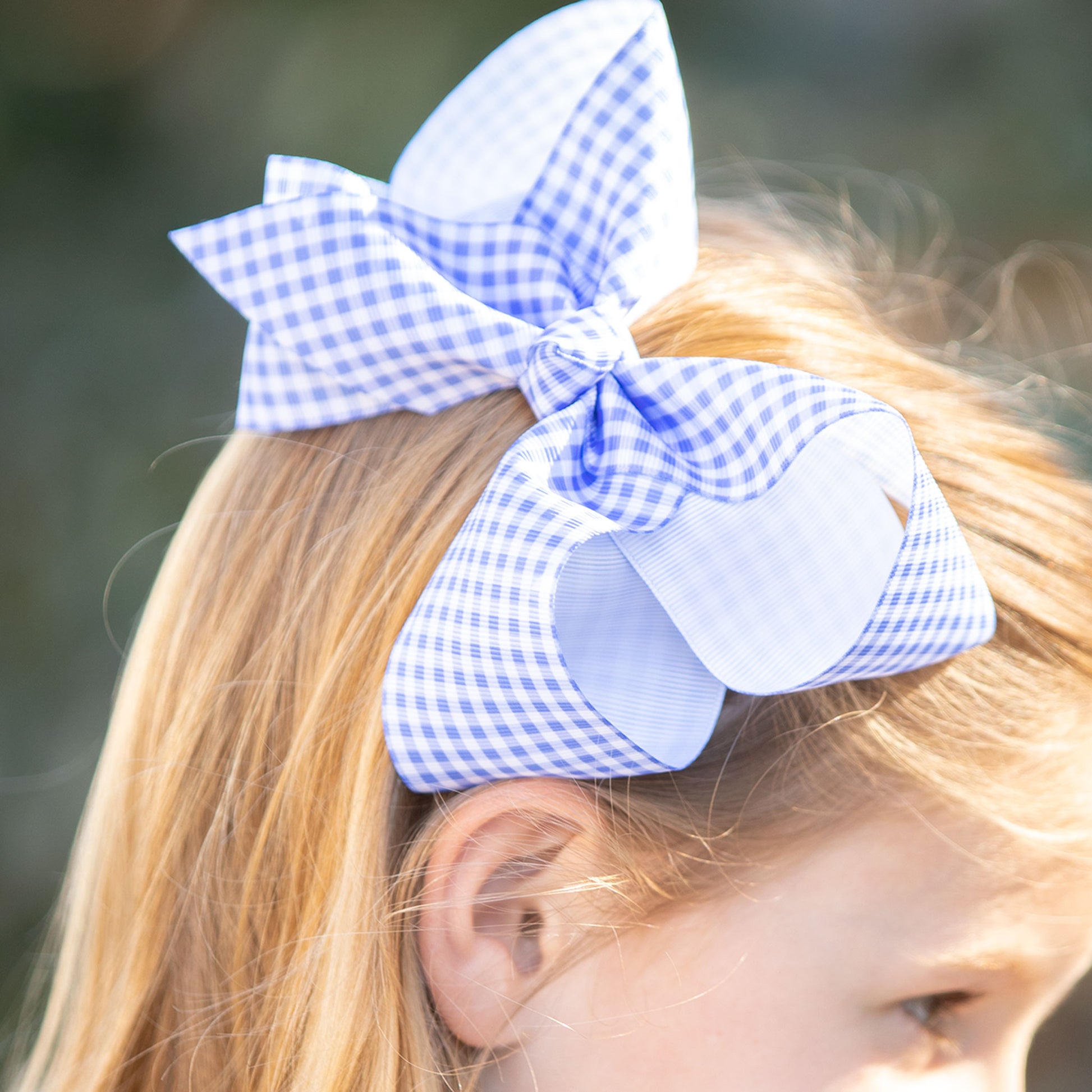 little girl wearing Blue Check Biggie Bow in her hair