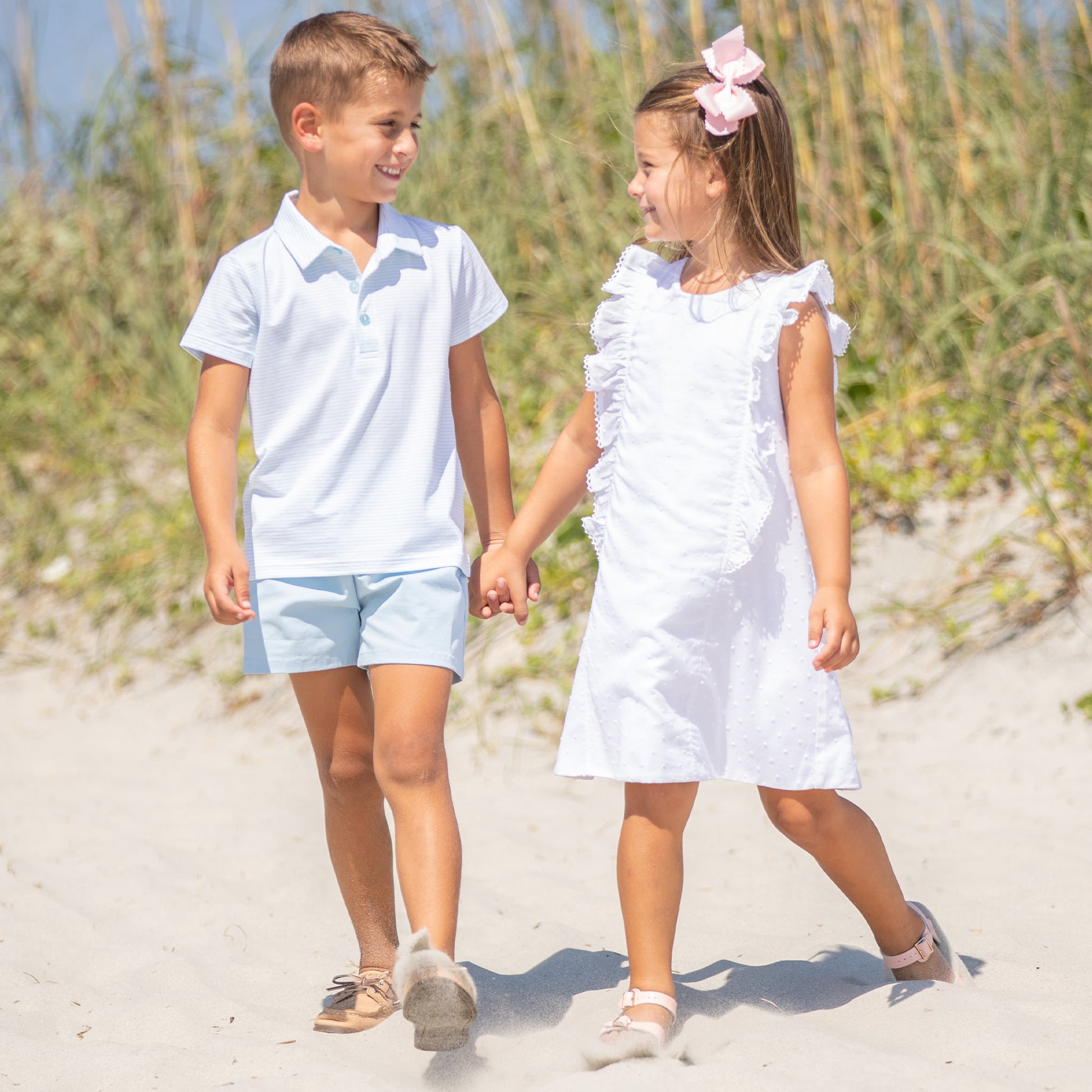 little girl wearing White Swiss Dot Easter Dress holding hands with a little boy