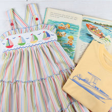 Load image into Gallery viewer, flatlay with a smocked dress, book, and Out To Sea Graphic Tee