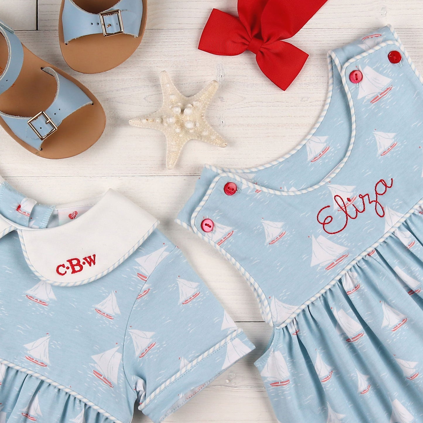 flatlay of sandals, red bow, starfish, monogrammed jumpers