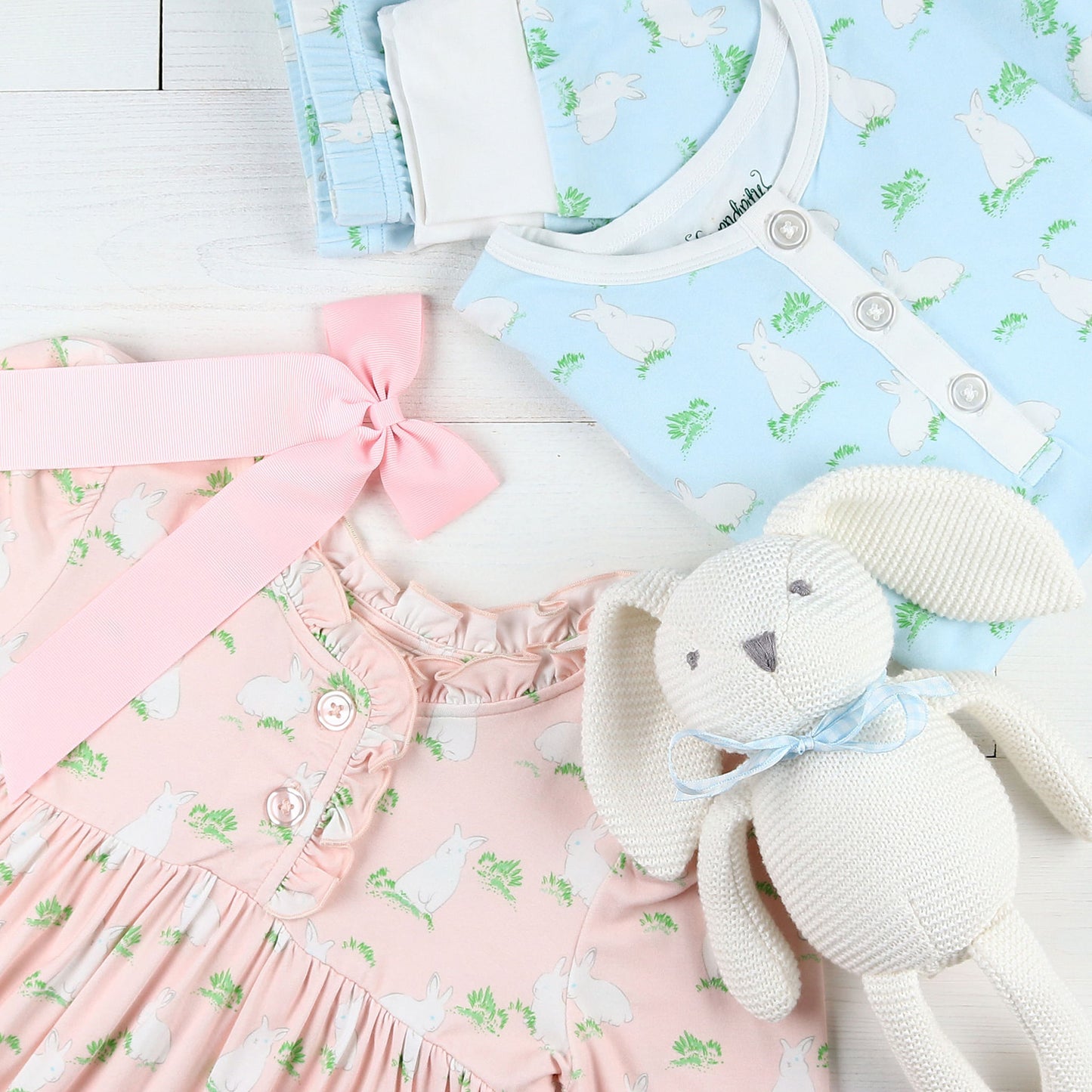 flatlay of a pink dress, bow, Hippity Hoppity Blue Lounge Set and stuffed animal rabbit