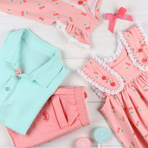 flat lay of aqua shirt, peach shorts and Girls Cherry Blossom Bubble