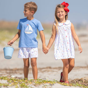 little boy wearing Sailboat Applique Shirt holding hands with his sister at the beach