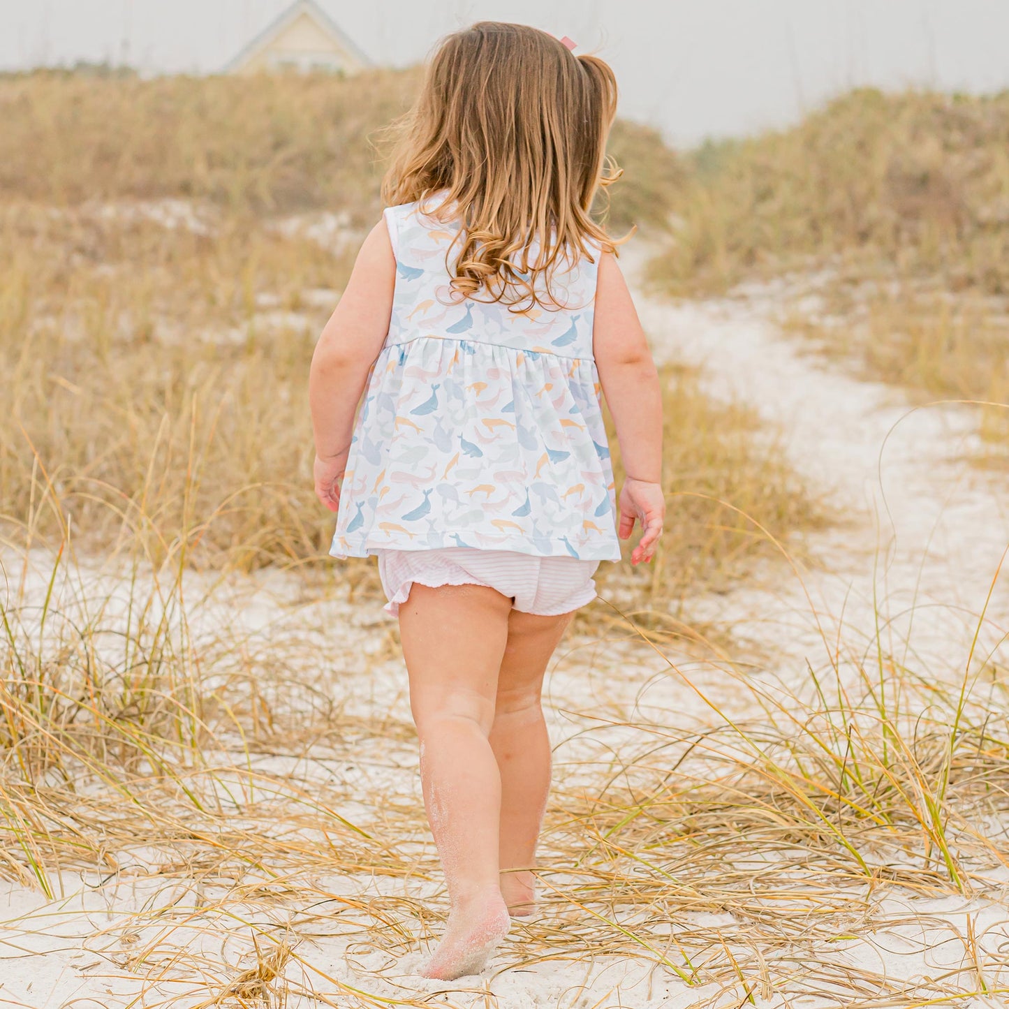 little girl walking o the beach