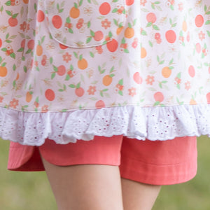 close up of a orange print shirt and Coral Twill Mary Shorts