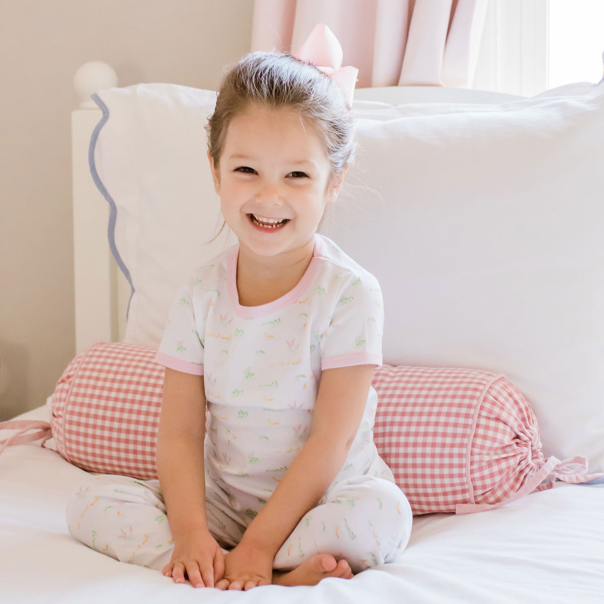 little girl sitting on her bed in her pajamas