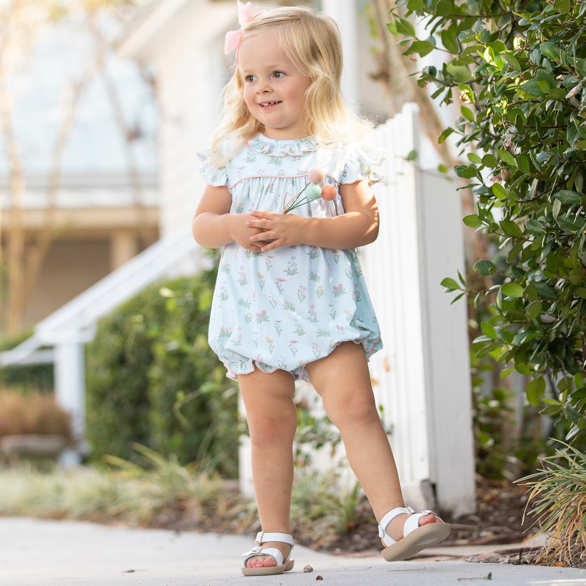 little girl wearing Girls Secret Garden Bubble standing on the sidewalk
