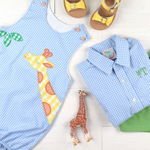 Load image into Gallery viewer, flatlay of giraffe jumper, blue checked oxford, green shorts, yellow sandals and toy giraffe