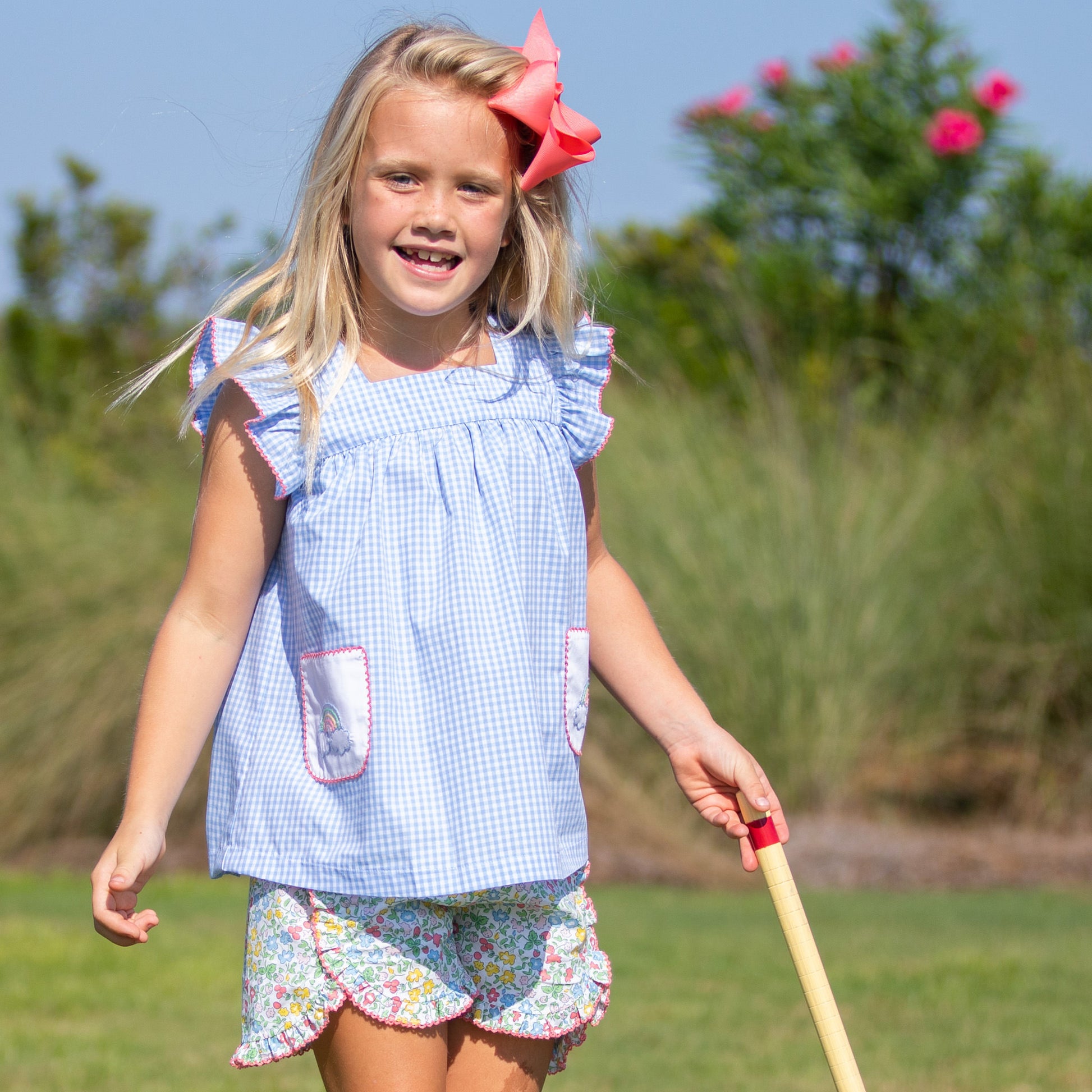 little girl plaiyng outside on a beautiful day