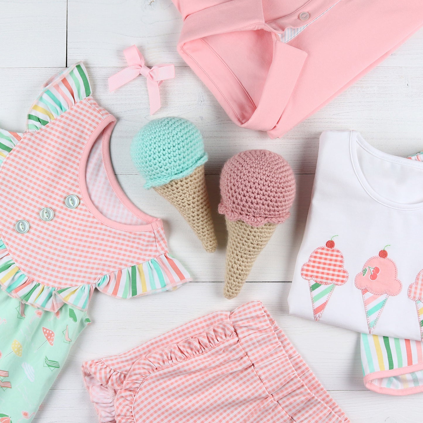 flatlay of ice cream shirt, dress, Tennis Club Ruffle Shorts, pink bow and a pink shirt