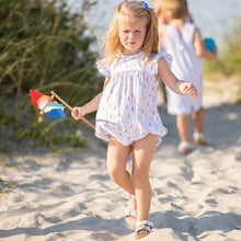 Load image into Gallery viewer, little girl holding a pinwheel walking on the beach