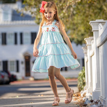 Load image into Gallery viewer, little girl in Under The Sea Smocked Twirl Dress with a peach bow in her hair