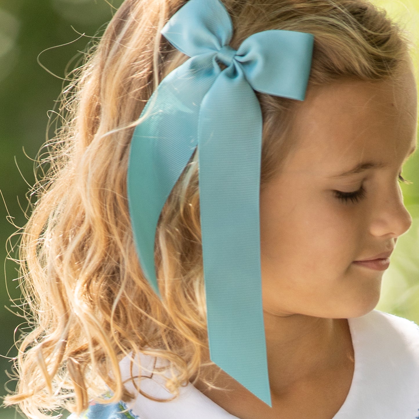 little girl wearing a Nile Blue Birdie Bow