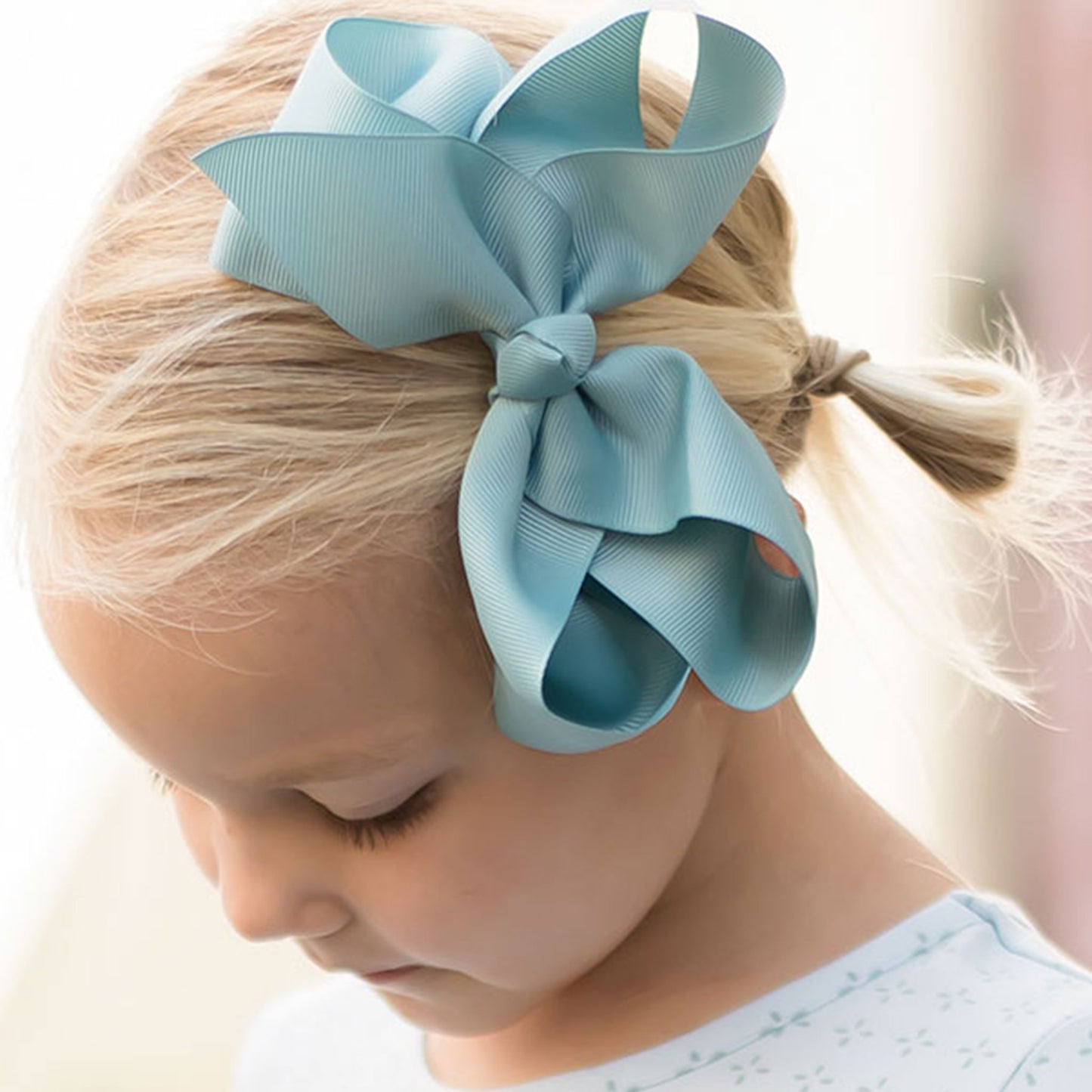 little girl wearing a Nile Blue Biggie Bow