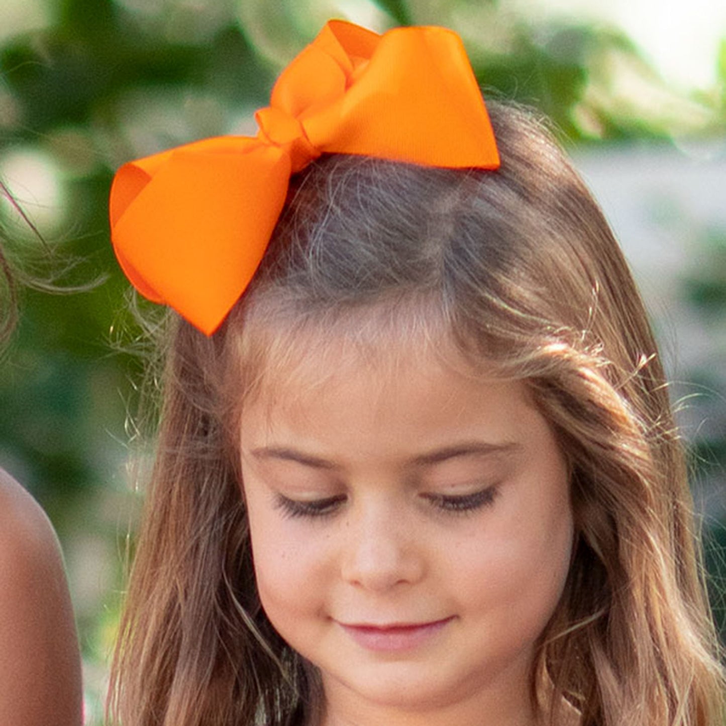 little girl wearing a Orange Biggie Bow