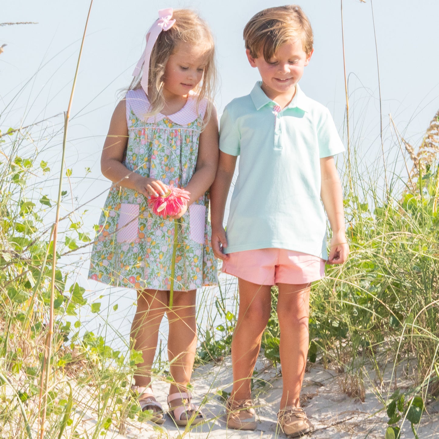 little boy wearing Salmon Shrimp Shorts and a little girl at the beach