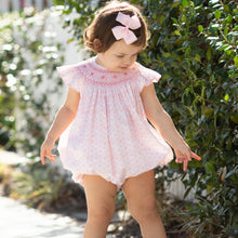 Load image into Gallery viewer, little girl wearing Petit Rose Smocked Bubble and a pink bow in her hair