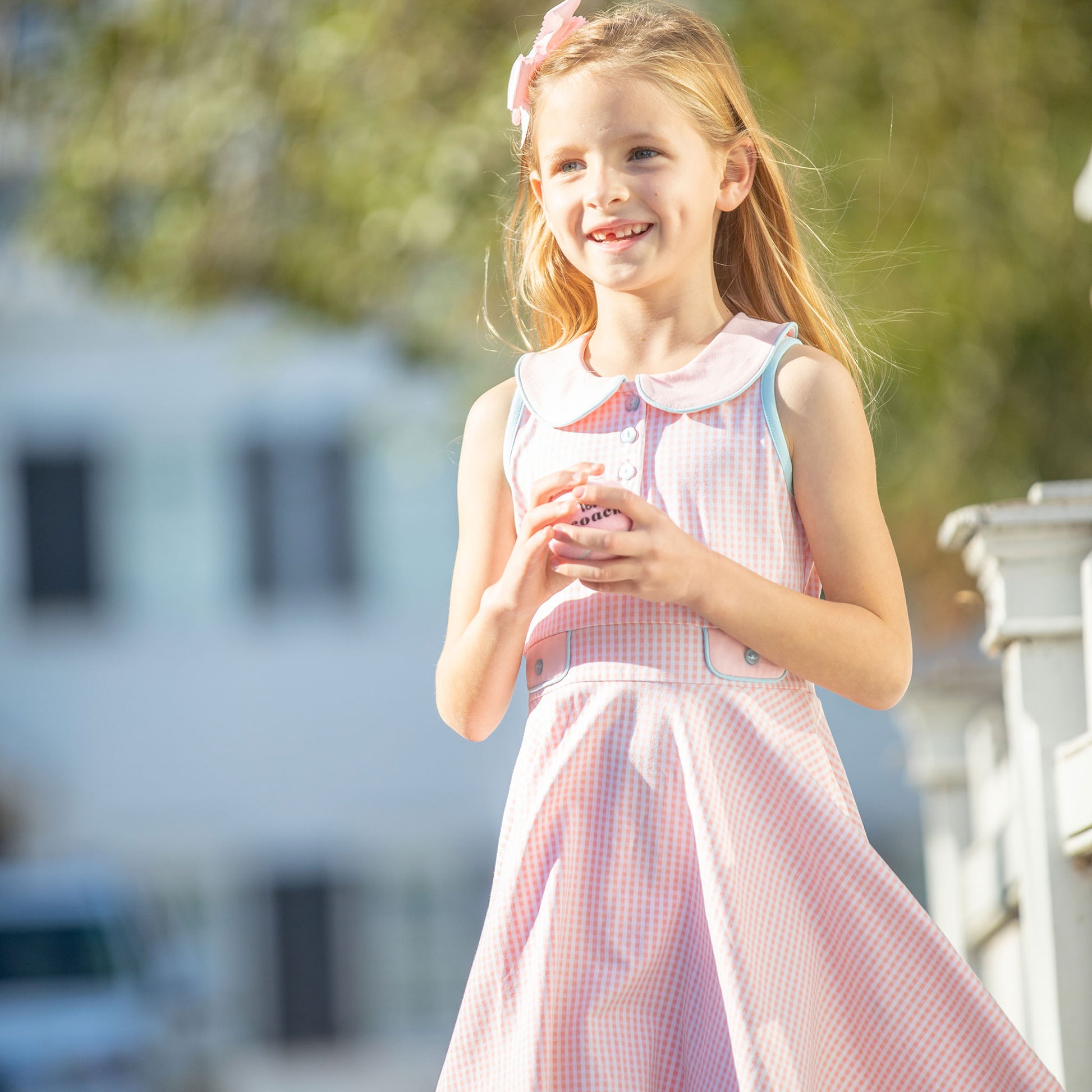 little girl smiling wearing Tennis Club Twirl Dress